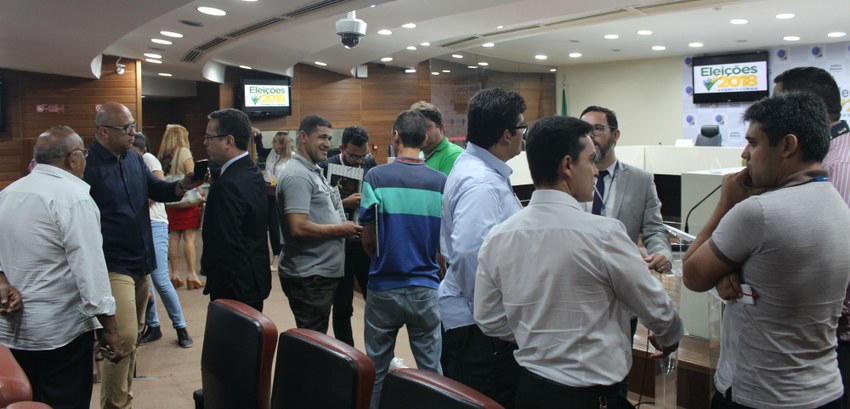 Foto de pessoas em pé e conversando durante a reunião com a imprensa realizada pelo TRE-PE.